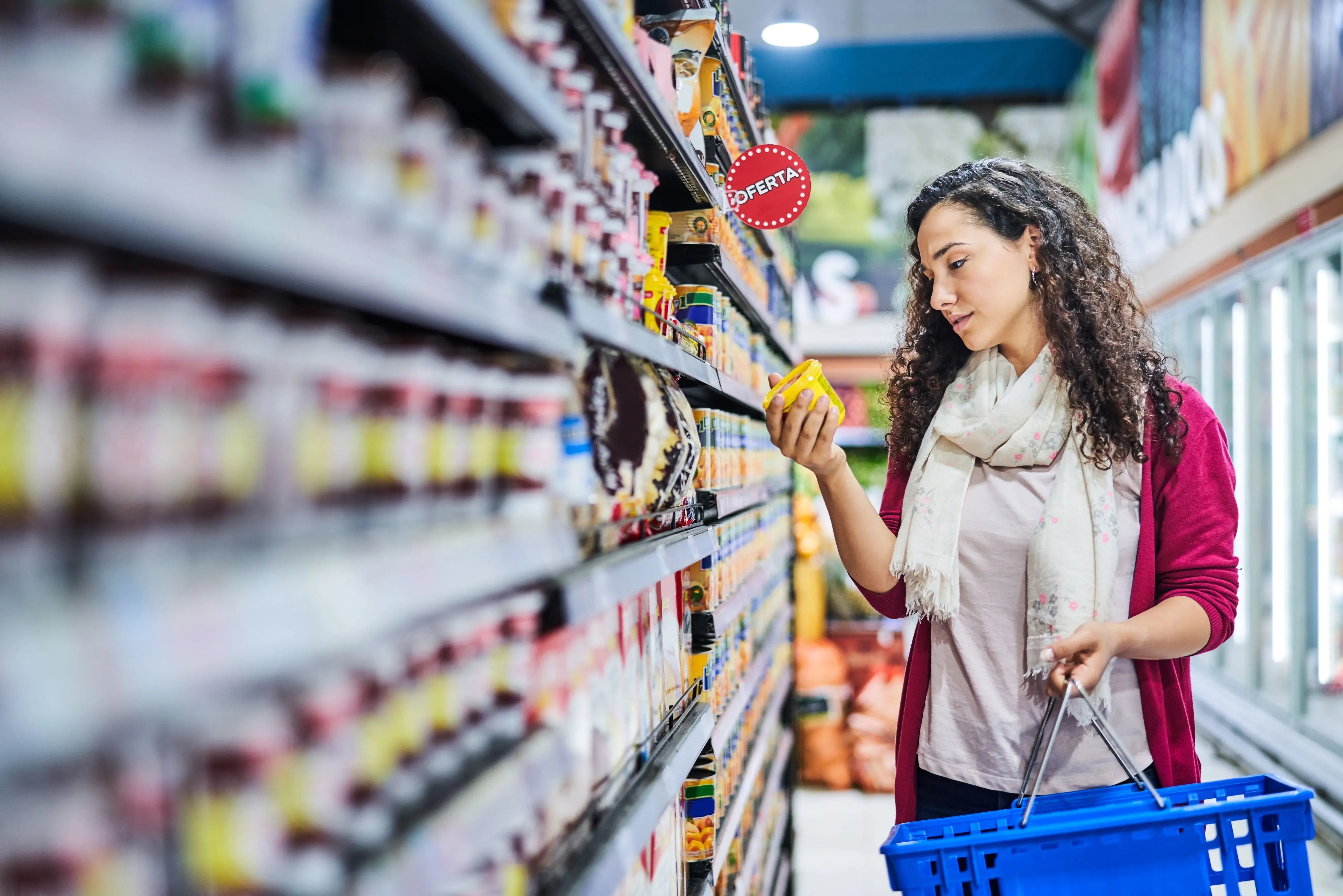 woman reading food labels at store