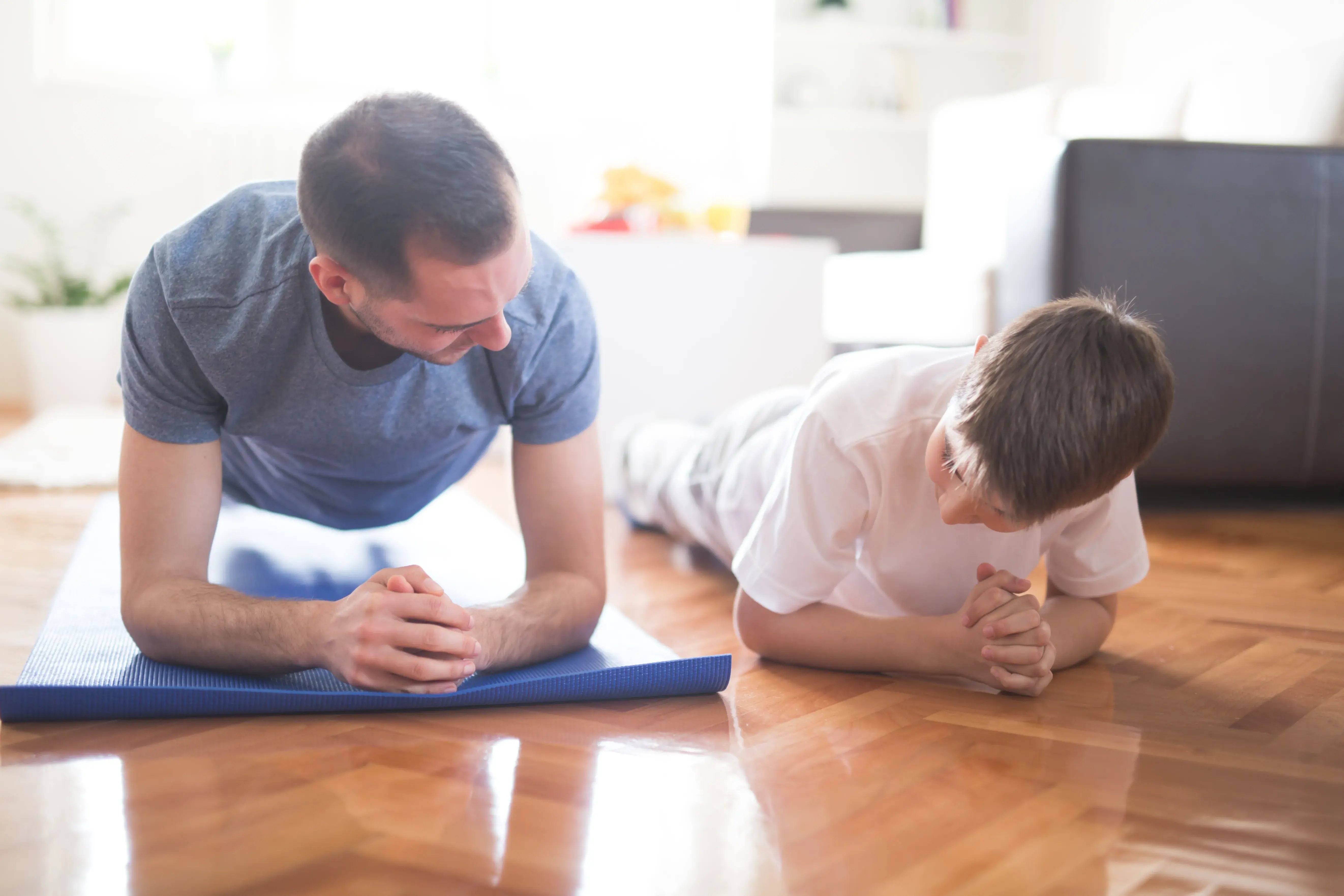 dad and son exercising at home