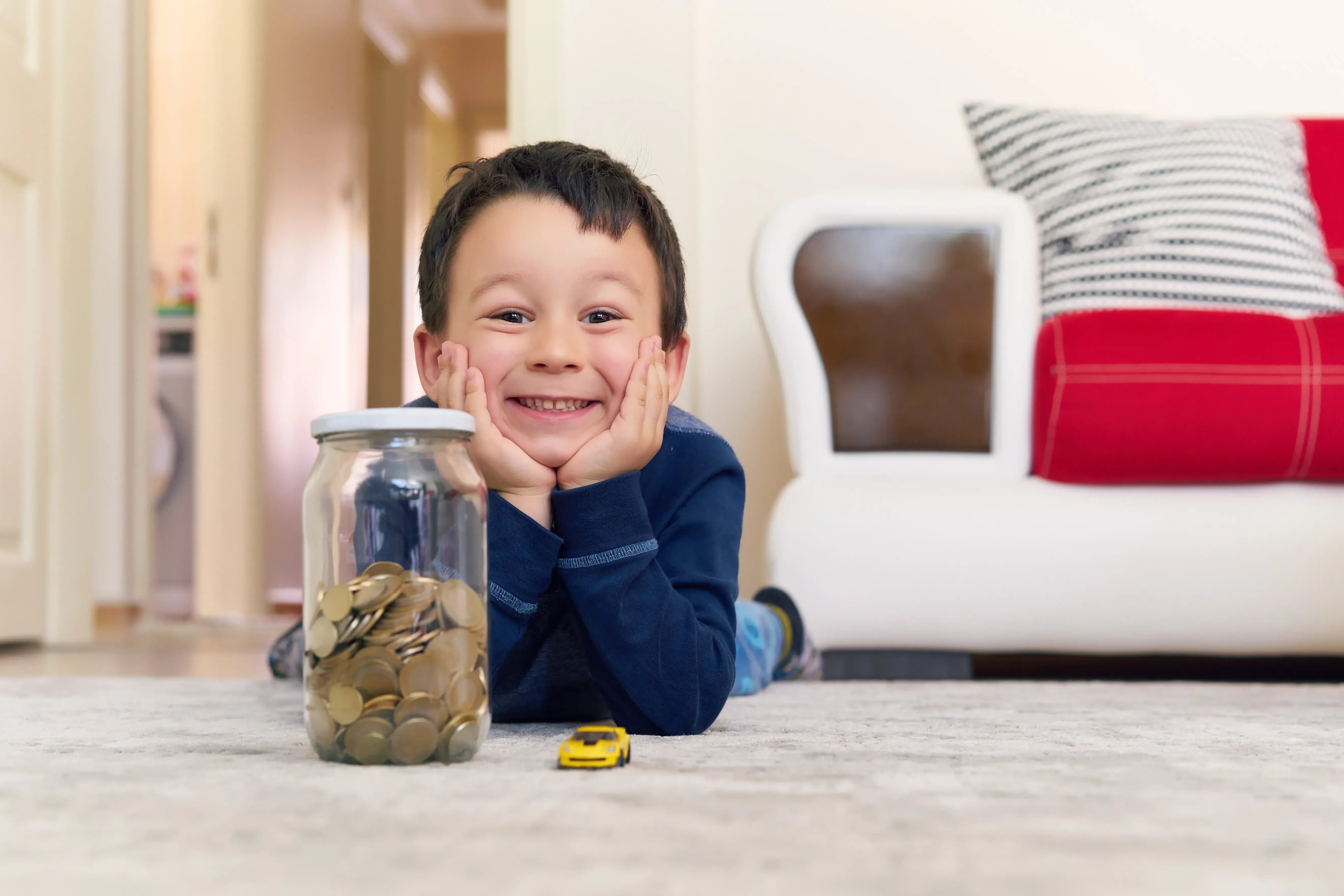 cute boy with savings in a jar