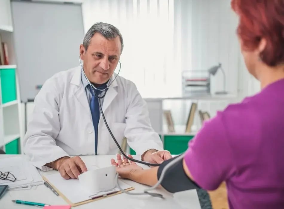 doctor checking blood pressure