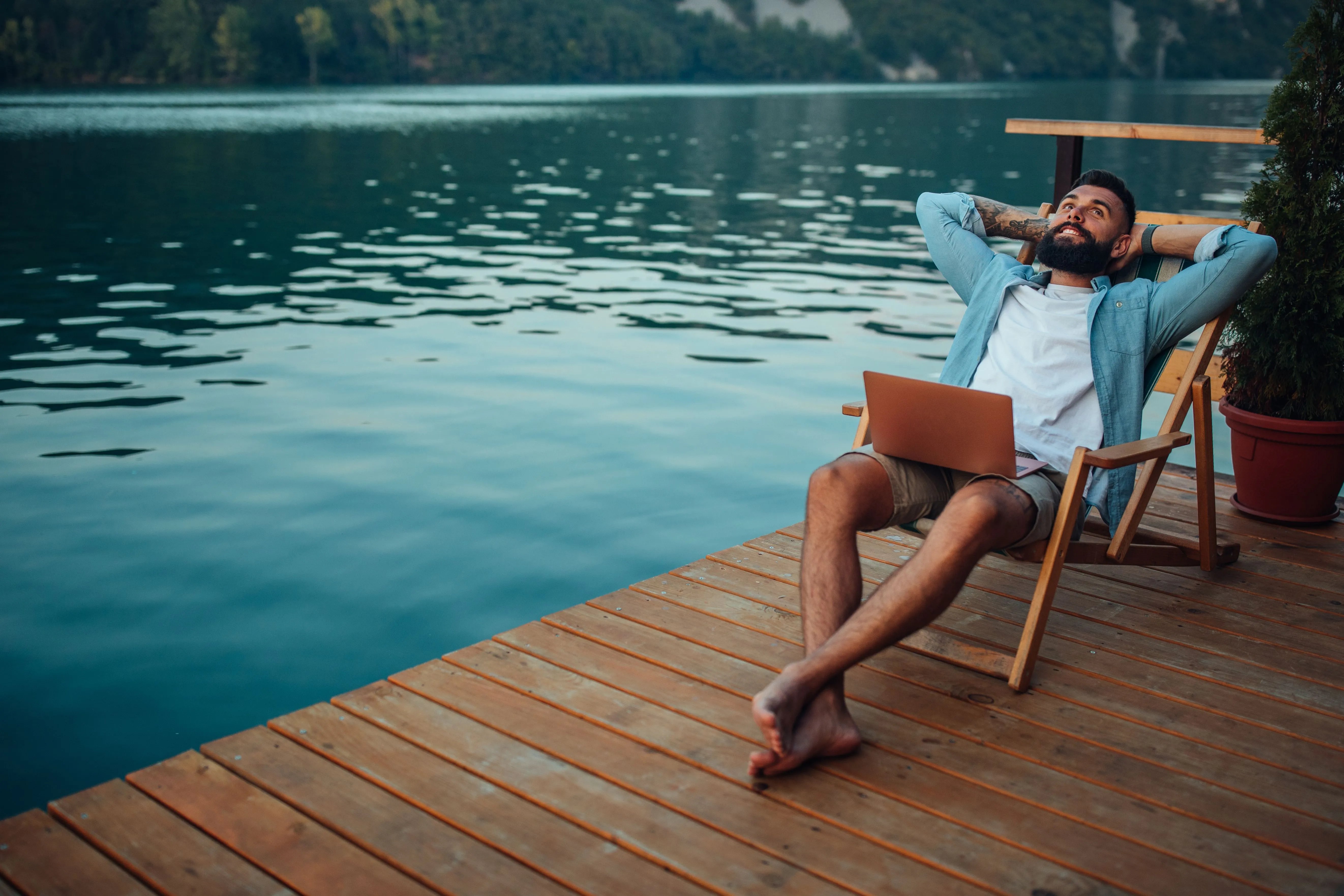 man relaxing next to water