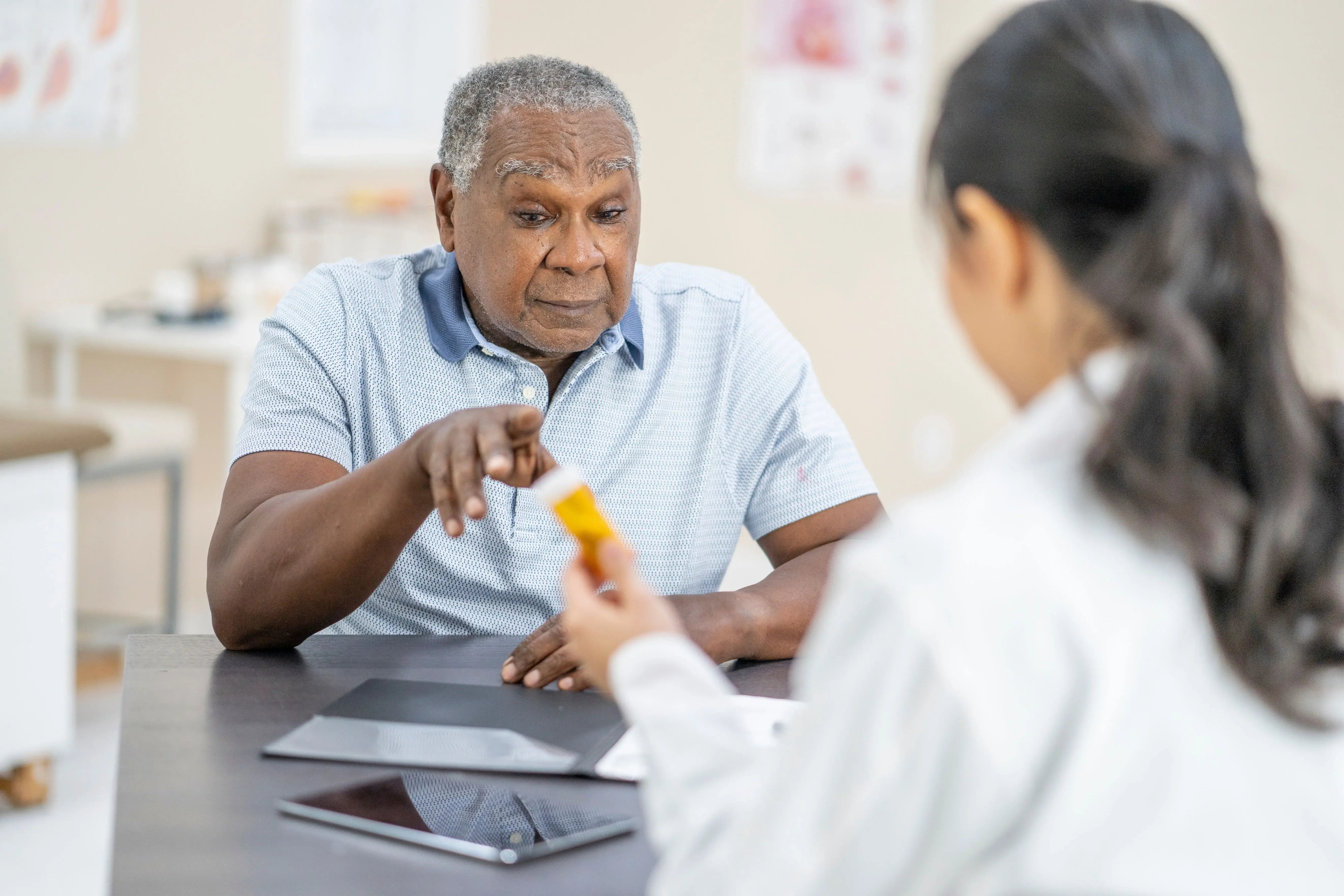 older man talking with doctor about prescription