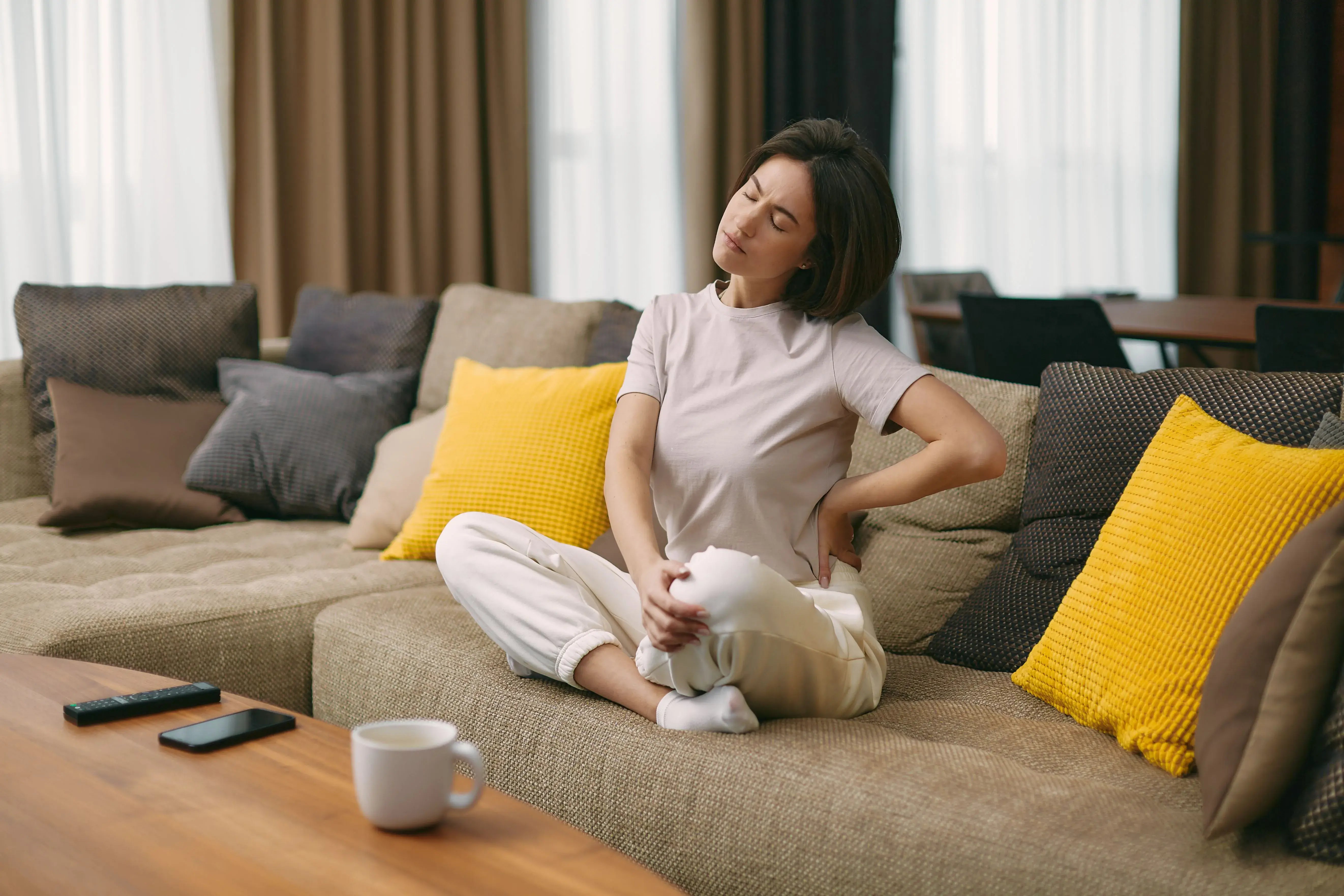 woman on couch in pain