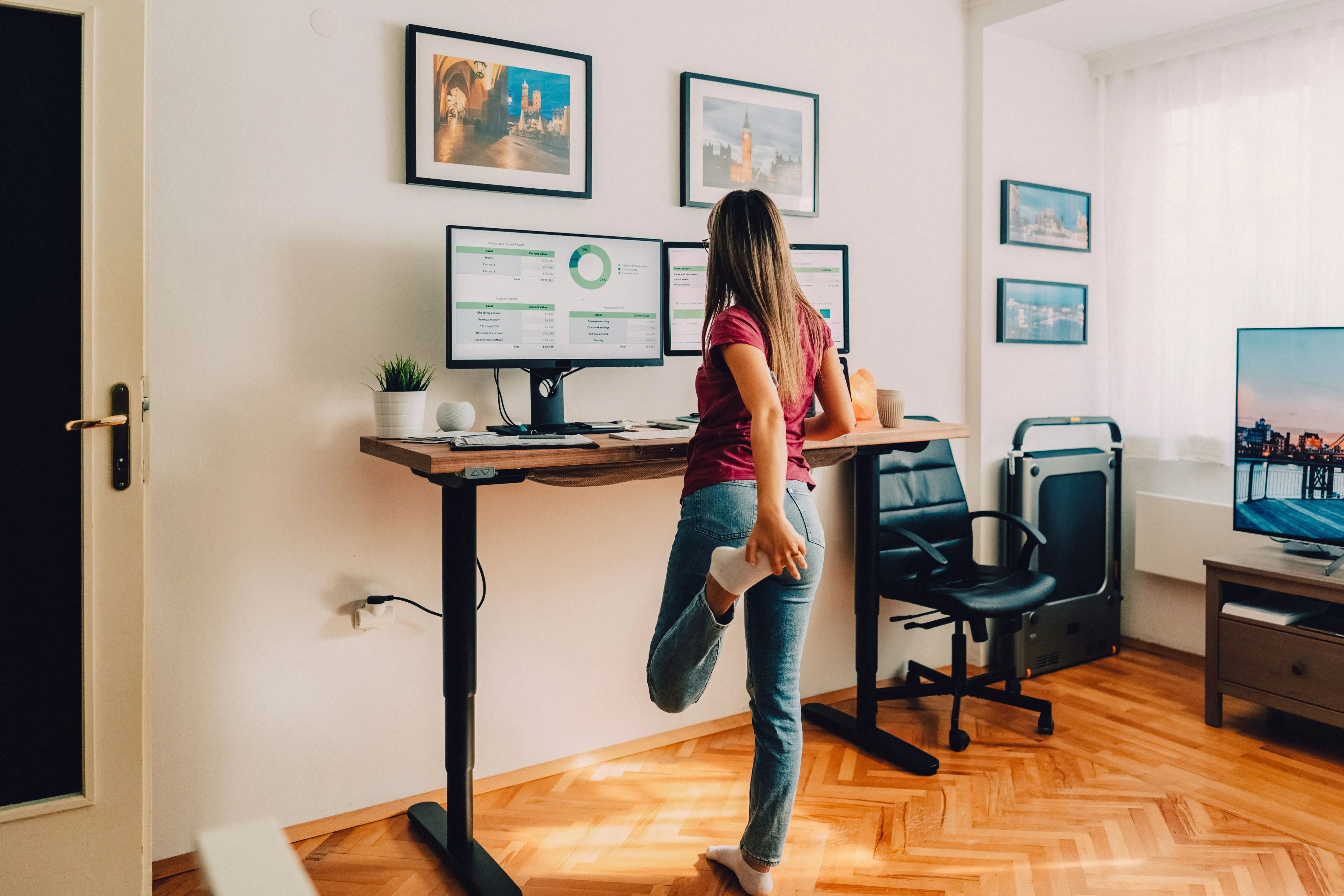 woman at stand up desk stretching