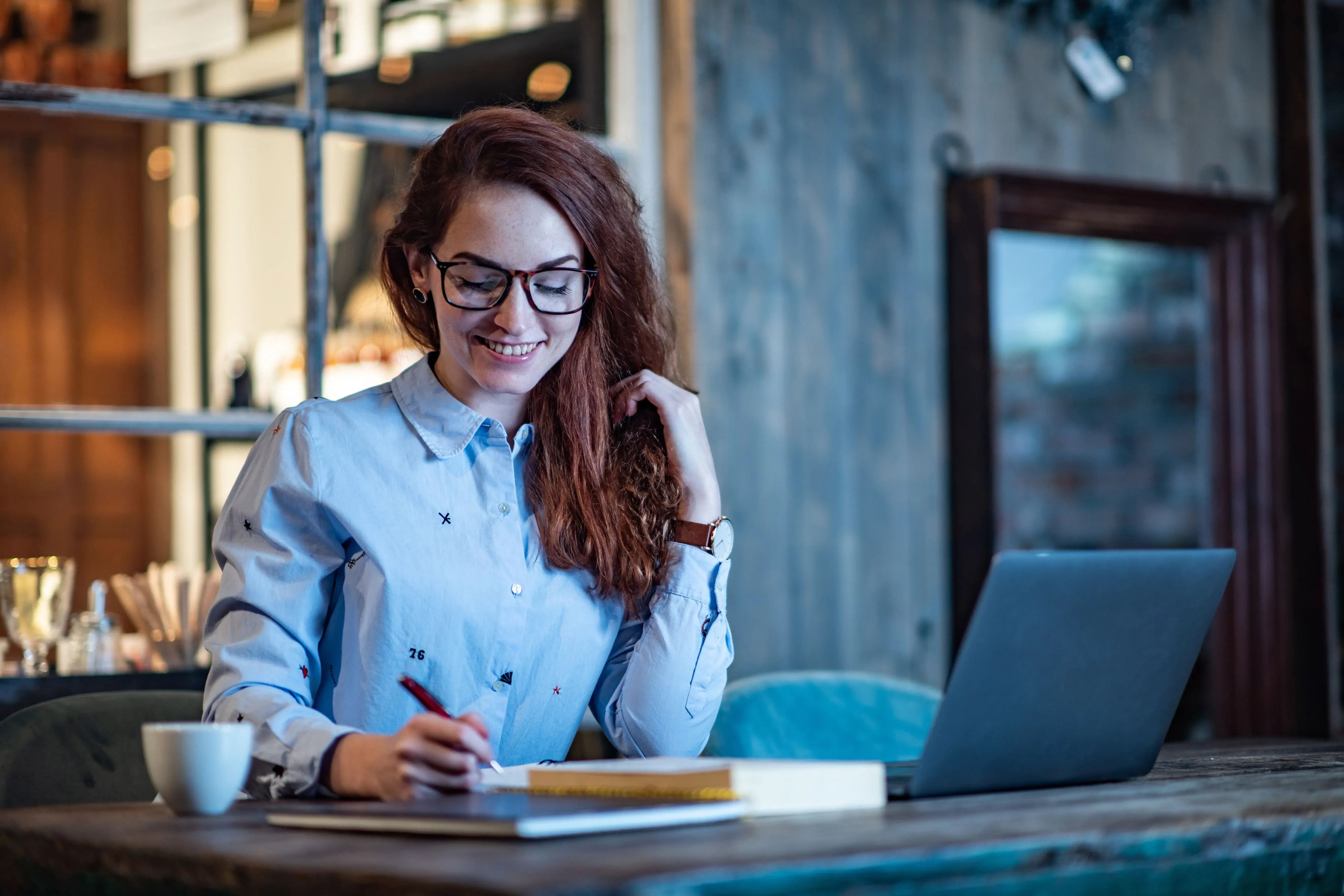 girl smiling writing a note