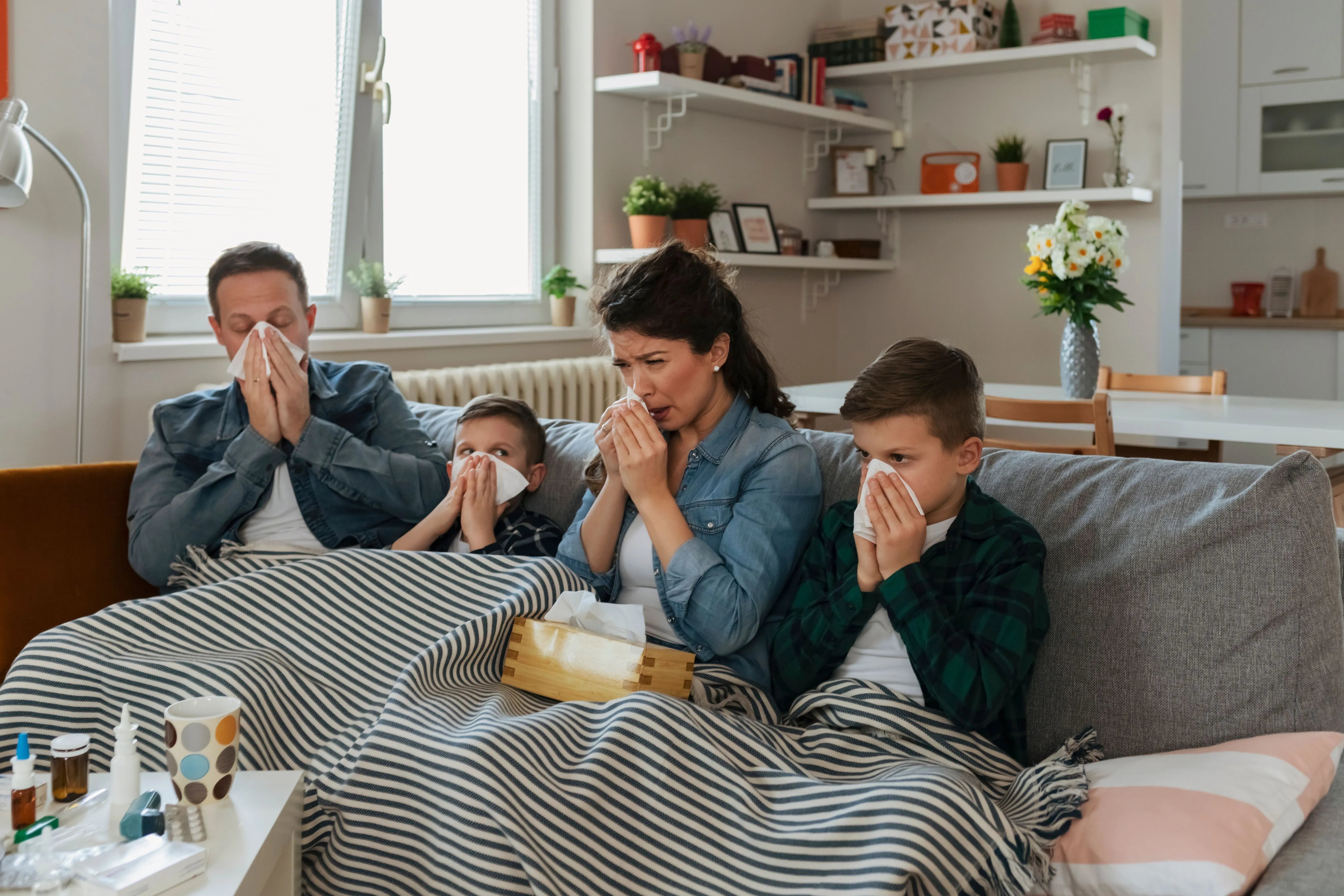 family on couch with a cold