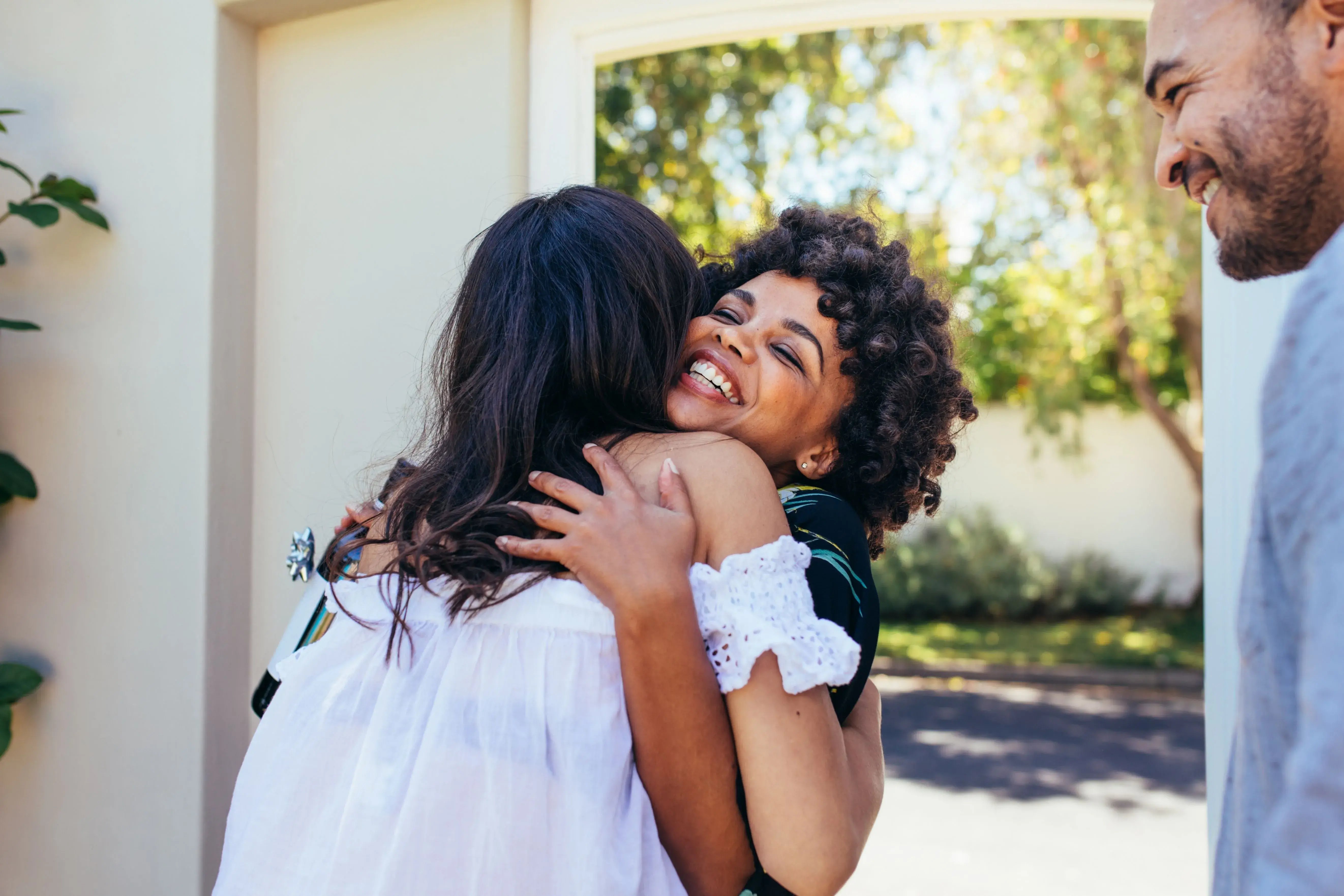 women hugging hello