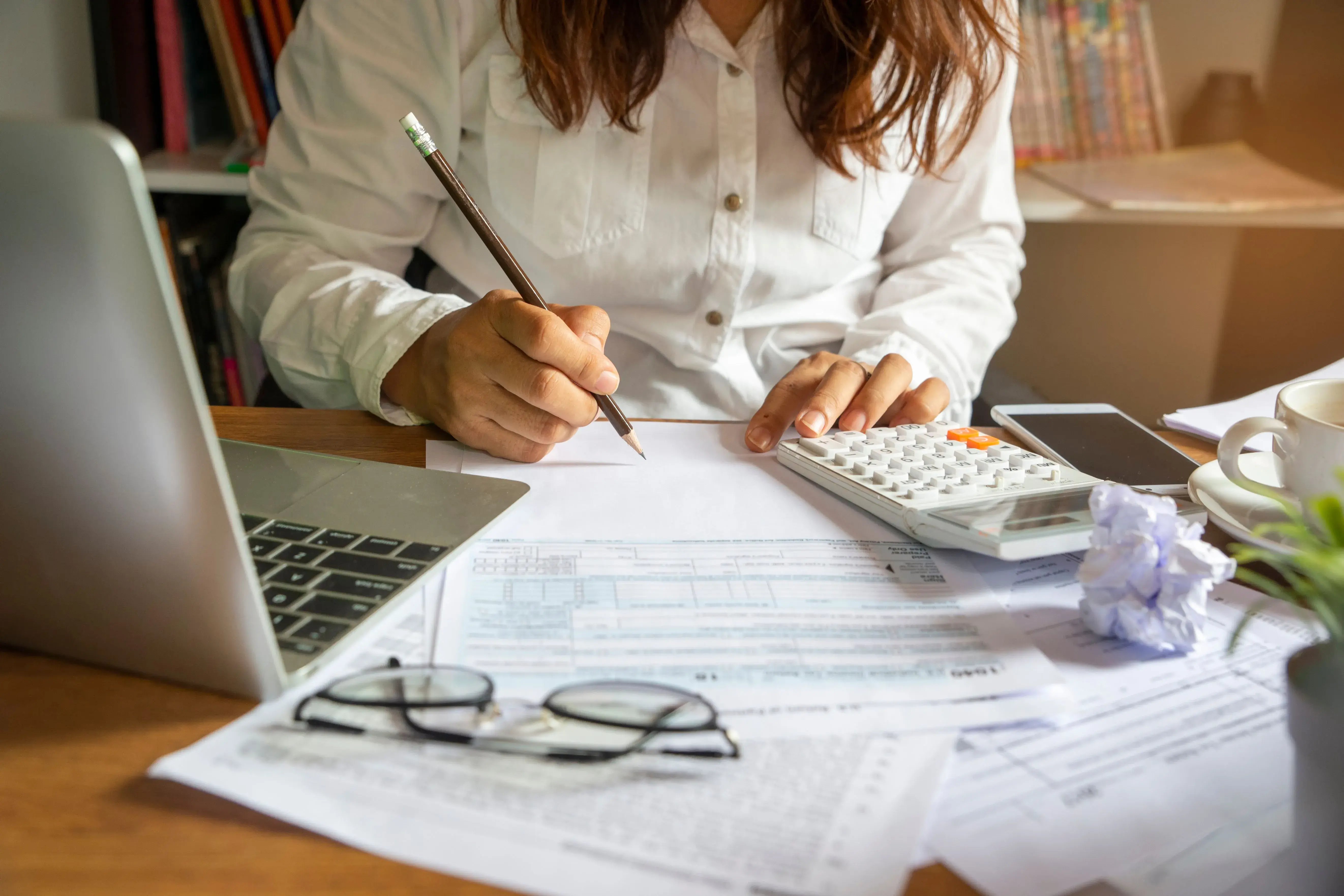 working on bills at desk