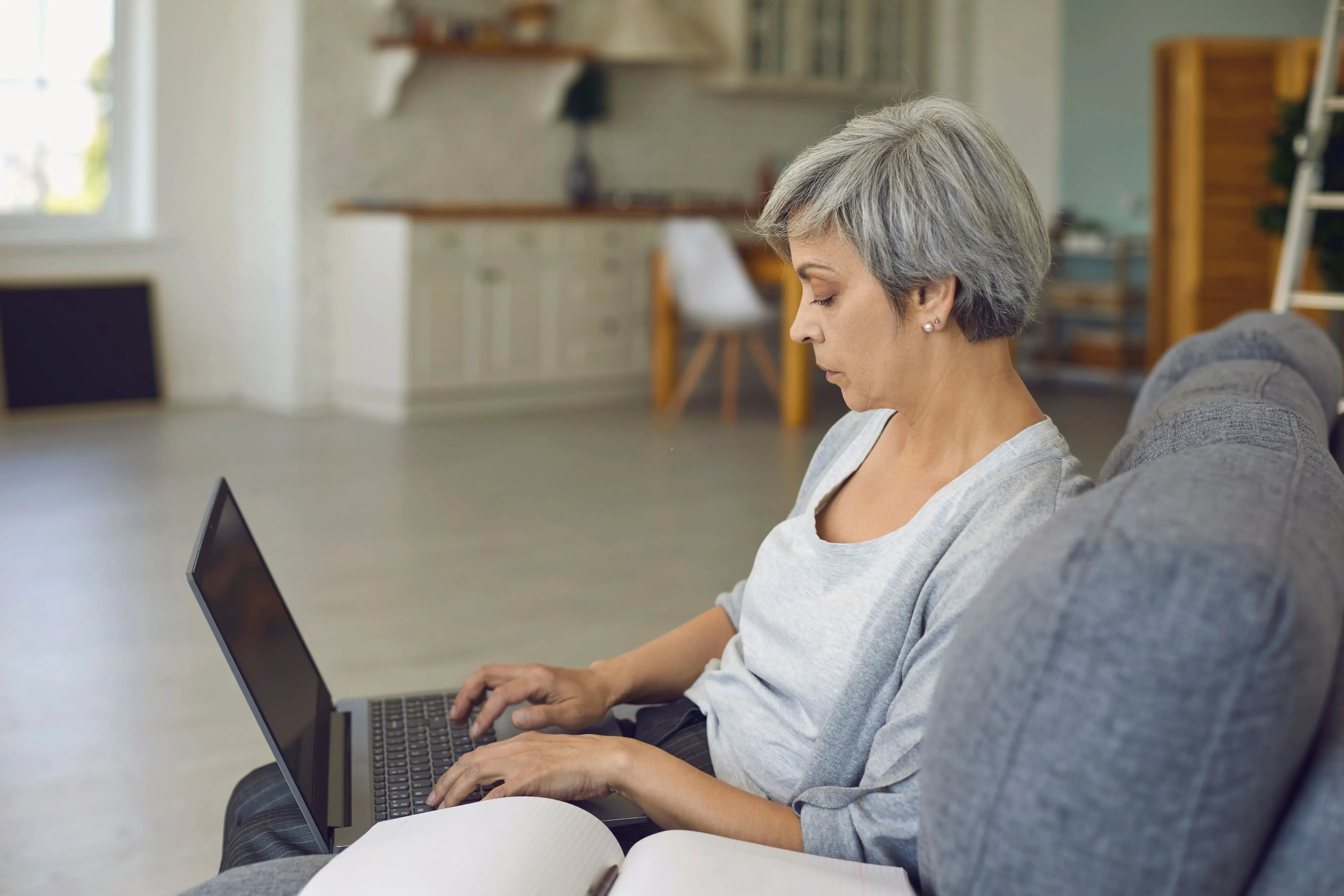 woman on laptop sitting on couch