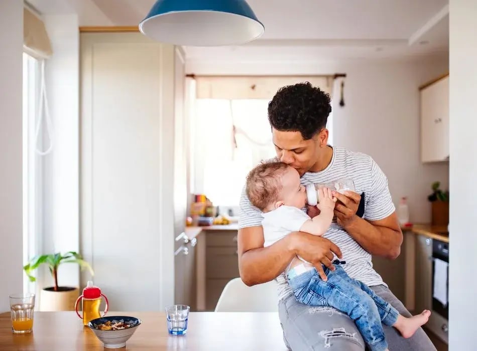 father feeding baby