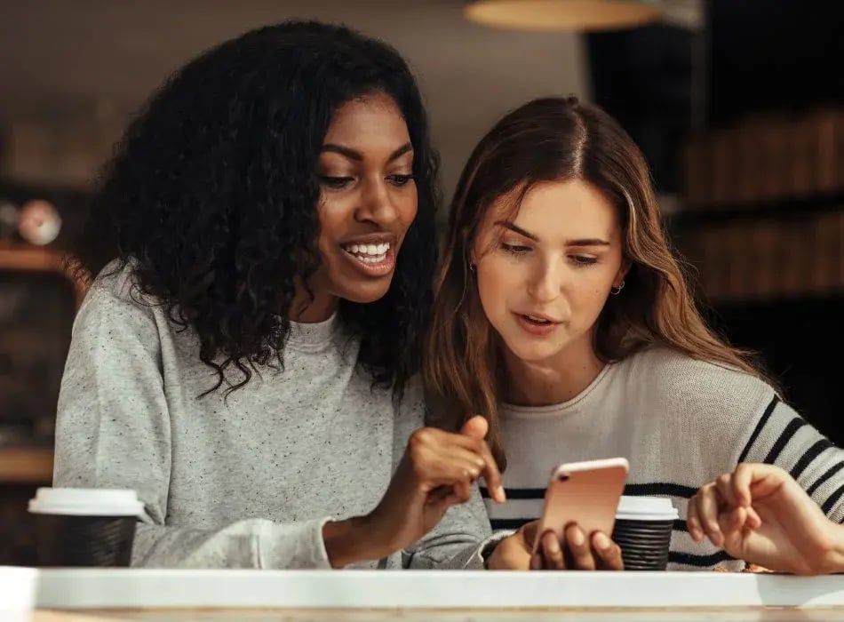 2 girl best friends looking at phone