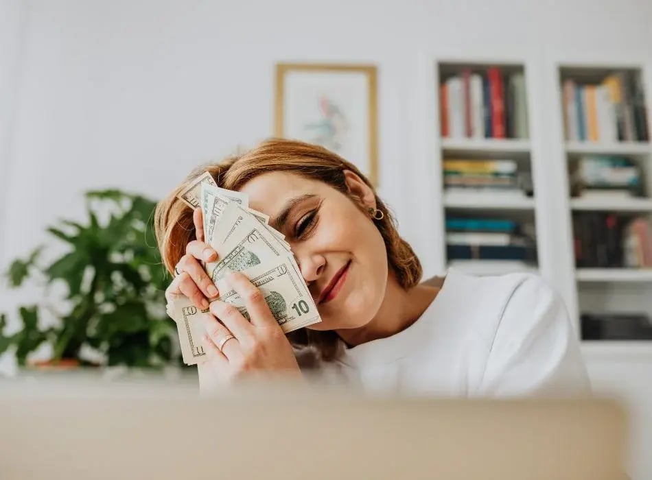 woman smiling with cash in hands