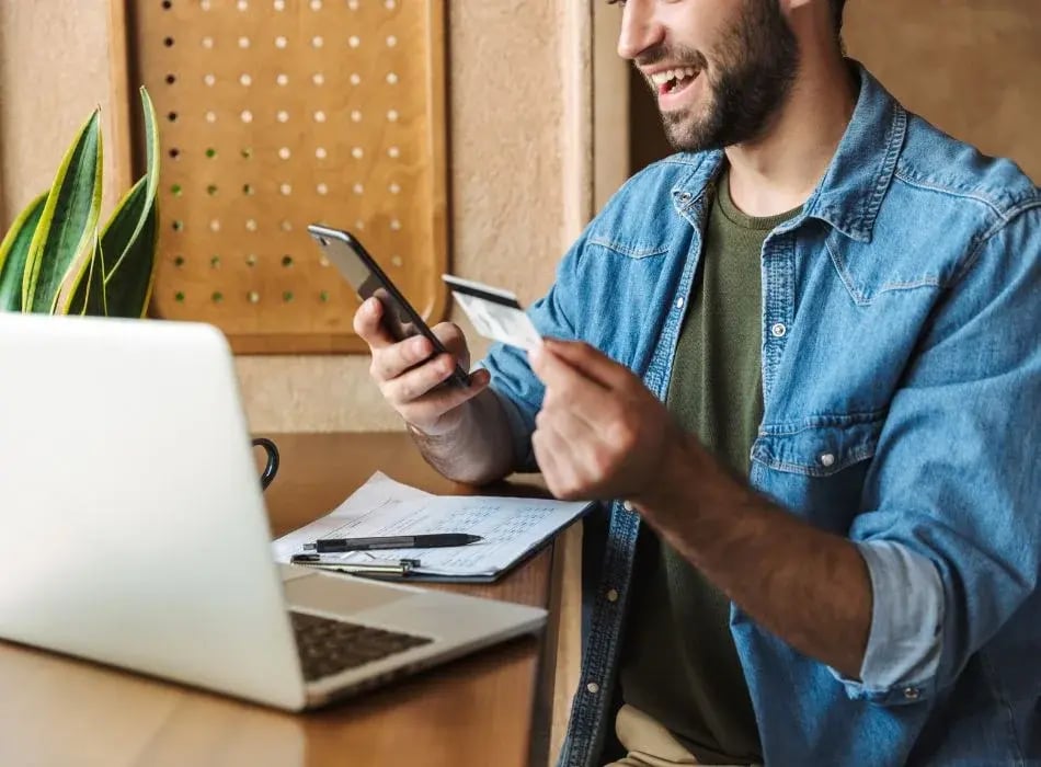 man with credit card at desk