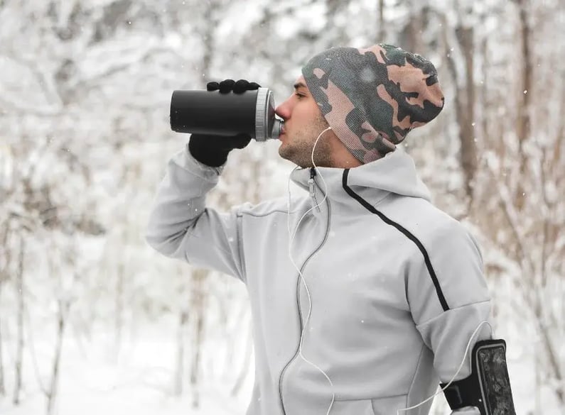 man drinking water outside